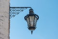 Old and vintage design street lamp bulb with blue sky background. Building illumination. Retro lantern lighting Royalty Free Stock Photo