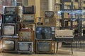 Old vintage dirty used TVs, radios, turntables for sale on night city street. Old technology concept