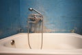 Old vintage dirty water tap in broken bathroom. Trash repairs. Grunge wall background