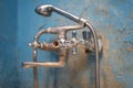 Old vintage dirty water tap in broken bathroom. Trash repairs. Grunge wall background