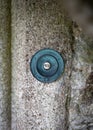 Old vintage door bell set into stone doorway. Large metal surrounding with the word press written on it. Royalty Free Stock Photo