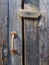 Old vintage door handles. Rusty metal locks and latches. Protective devices for wooden yard gates Royalty Free Stock Photo