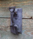 Old vintage doorbell on the door knockers in the form of a shovel