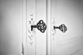 Old vintage doors with antique skeleton keys in lock, retro background texture black and white Royalty Free Stock Photo