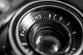 Old, vintage film camera  lens close up macro shot in black and white Royalty Free Stock Photo