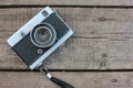 Old vintage film camera on rough wooden background with copy space. Top view Royalty Free Stock Photo