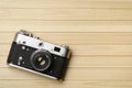 Old vintage film camera on wooden background, top view Royalty Free Stock Photo