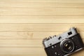 Old vintage film camera on wooden background, top view