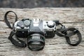 Old vintage film camera on wooden textured background