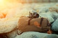 Old vintage film medium format camera lies on the stones against the backdrop of a canvas vintage backpack