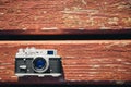 Old vintage film photo camera lying on wooden background. Copy space. Top view Royalty Free Stock Photo