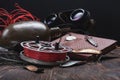 Old vintage fishing reel and baits. Aluminum round fishing reel and red line. Soviet book and binoculars Royalty Free Stock Photo