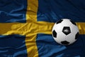 Vintage football ball on the waveing national flag of sweden background. 3D illustration Royalty Free Stock Photo