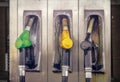 Old vintage gas station with three nozzles in green, yellow and black colors, closeup Royalty Free Stock Photo