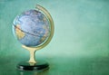 Old vintage globe on a textured green background Royalty Free Stock Photo