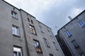 Old vintage grey slum house with damaged walls and outcast sky in background Royalty Free Stock Photo