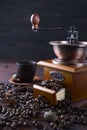 Old vintage grinder with roasted coffee beans and grind coffee on stone background. Royalty Free Stock Photo