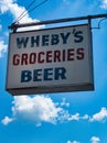 Vintage grocery sign with sky background