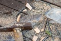 Old vintage hammer, wood saw, nails, safety glasses and sawdust on a wooden background, close-up, selective focus Royalty Free Stock Photo