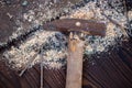 Old vintage hammer, wood saw, nails and sawdust on a wooden background, close-up, selective focus Royalty Free Stock Photo