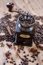 old vintage hand grinder with Coffee beans and spices on wooden table Royalty Free Stock Photo