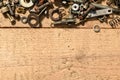 Old vintage hand tools - set of screws and nuts on a wooden background with blank space for text Royalty Free Stock Photo