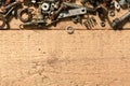 Old vintage hand tools - set of screws and nuts on a wooden background with blank space for text Royalty Free Stock Photo