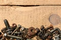 old vintage hand tools - set of screws and nuts on a wooden background with blank space for text Royalty Free Stock Photo