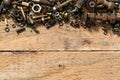 old vintage hand tools - set of screws and nuts on a wooden background with blank space for text Royalty Free Stock Photo