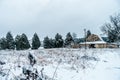 Old vintage historic barn on farm covered in snow Royalty Free Stock Photo