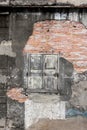 Old vintage house, background texture of a cracked and eroded wall, old bricks in the ancient cement with cracks, old wooden Royalty Free Stock Photo