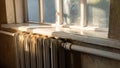 Old vintage house interior in sunset light. Cast iron radiator and wooden window Royalty Free Stock Photo