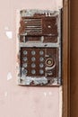 Old vintage intercom doorbell on apartment building doors