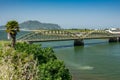 Old vintage iron bridge over the green river Royalty Free Stock Photo