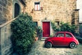 Old Vintage Italian Scene. Small Antique Red Car. Fiat 500