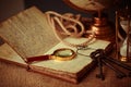 Old vintage items of the treasure hunter, traveler and discoverer - a magnifying glass, old manuscripts, a globe, keys to chests. Royalty Free Stock Photo