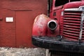 Old Vintage Junk 1950s Red Fire Truck Abandoned Parked in Front of Brick Building in City Royalty Free Stock Photo