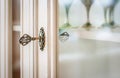 Old vintage key in a glass cupboard lock. wineglass inside. Close-up