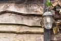 Old vintage lamp on wooden fence