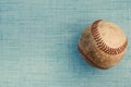 Old vintage leather baseball on blue linen texture background Royalty Free Stock Photo