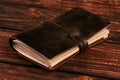 Old vintage leather book on wooden background Royalty Free Stock Photo