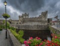 Old vintage lit street lamp in front of Cahir castle and moat in Cahir town Royalty Free Stock Photo