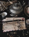 Old vintage looking bundle of postcards hand written in cursive on a dark black messy table