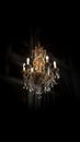 Old vintage luxury rich chandelier on dark background. AI generative Royalty Free Stock Photo