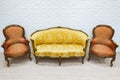 Old vintage luxury sofa and pair of armchairs. Royalty Free Stock Photo