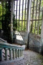 Old vintage marble spiral staircase at abandoned overgrown mansion Royalty Free Stock Photo