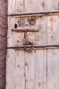 Old vintage massive wooden door with metal locker and handle Royalty Free Stock Photo