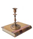An old vintage metal bronze candlestick on the old book Royalty Free Stock Photo