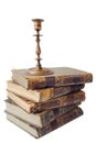 An old vintage metal bronze candlestick on the pile of old books Royalty Free Stock Photo