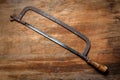 Old vintage metal hacksaw of the last century extracted from the chest in the workshop of grandfather. Background for Royalty Free Stock Photo